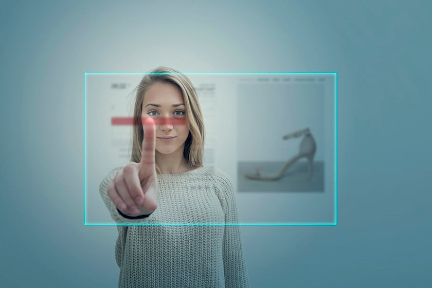 Young woman using virtual reality simulator touching screen for make a shopping online